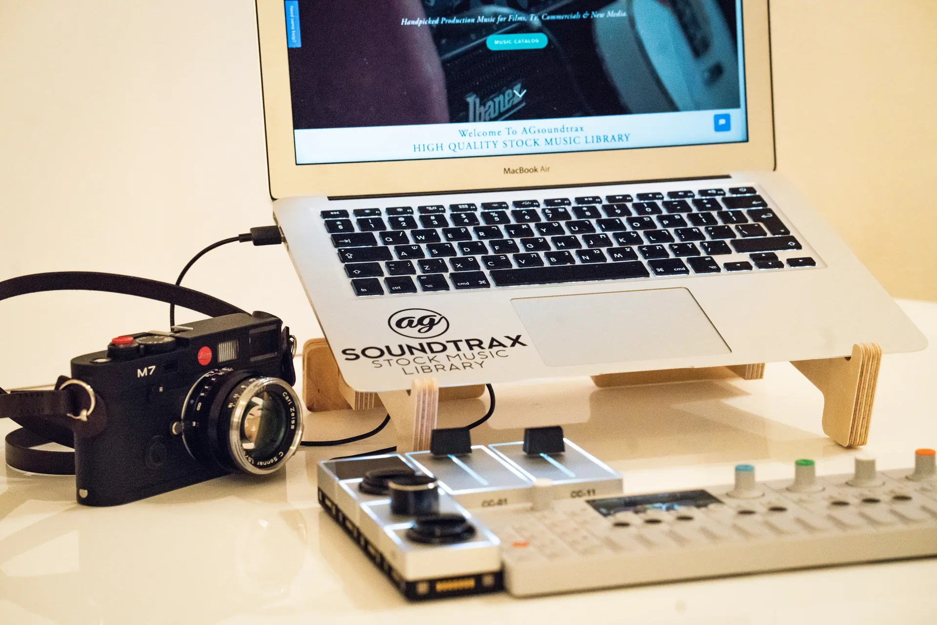 Creative studio setup with laptop, camera and music production gear